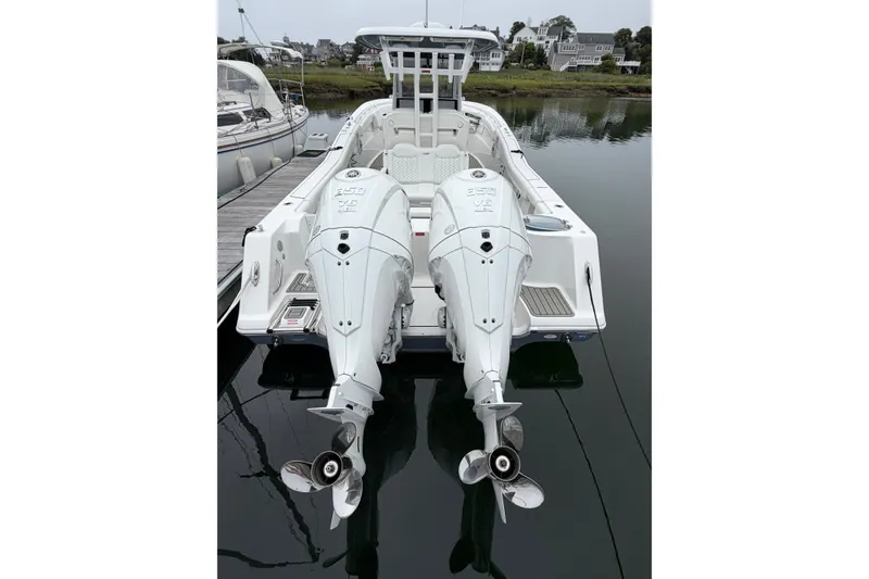 Slide: The Image of 2026 Tidewater 320 CC Adventure boat with dual outboard engines docked in a marina. - 55