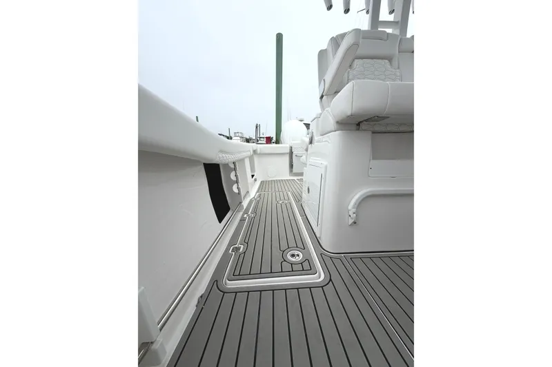 Slide: The Image of 2026 Tidewater 320 CC Adventure boat interior with sleek seating and modern flooring. - 21