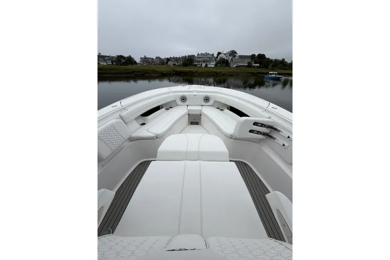 Slide: The Image of 2026 Tidewater 320 CC Adventure boat interior with white seating and scenic waterfront view. - 41