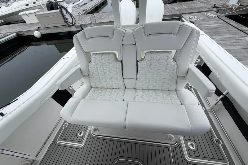Slide: The Image of 2026 Tidewater 320 CC Adventure boat with luxurious white seating at the dock. - 62