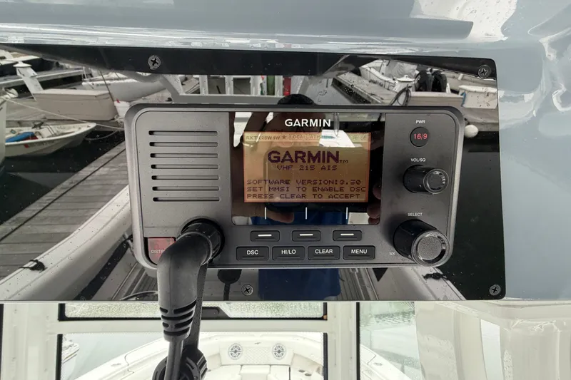 Slide: The Image of Garmin marine radio on 2026 Tidewater 320 CC Adventure boat, docked with visible controls. - 15