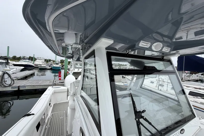 Slide: The Image of 2026 Tidewater 320 CC Adventure boat docked at marina, showcasing sleek design and modern features. - 13