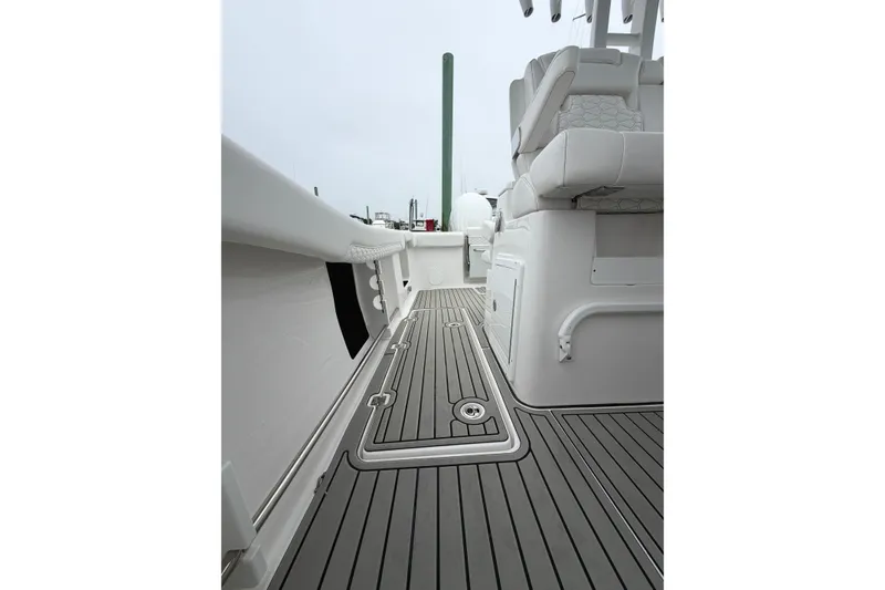 Slide: The Image of 2026 Tidewater 320 CC Adventure boat interior with sleek seating and modern deck design. - 60