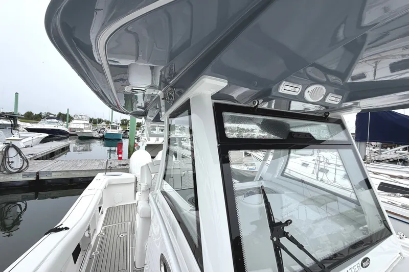 Slide: The Image of 2026 Tidewater 320 CC Adventure boat docked at marina, showcasing sleek design and modern features. - 52