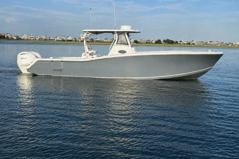 The Image of 2026 Tidewater 320 CC Adventure boat on calm water, side view. - 0