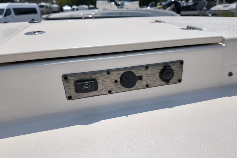Slide: The Image of Control panel on a 2027 Carolina Skiff 21LS boat, featuring switches and outlets. - 18