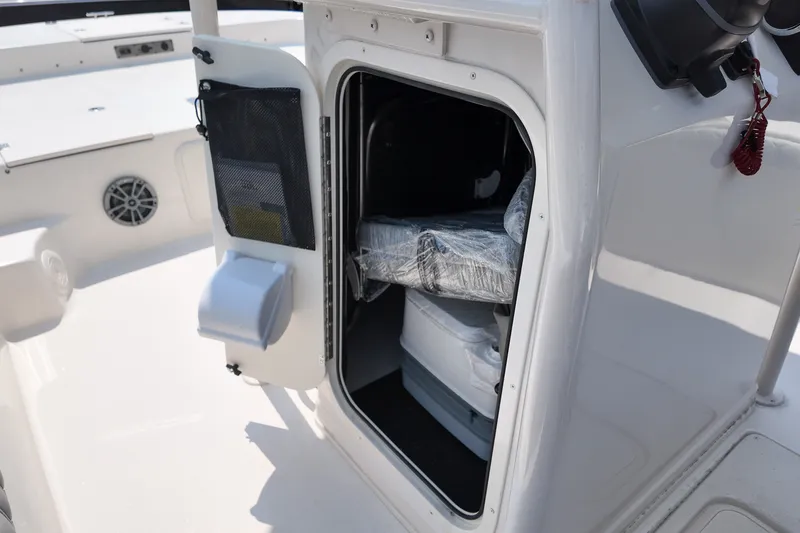 Slide: The Image of 2027 Carolina Skiff 21LS boat storage compartment with open door, showcasing interior space. - 17