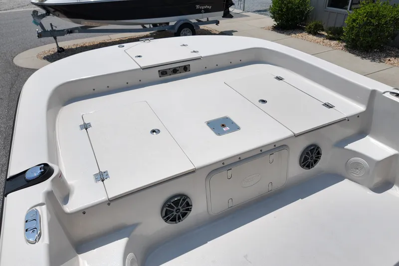 Slide: The Image of 2027 Carolina Skiff 21LS boat deck with storage compartments and speakers. - 14