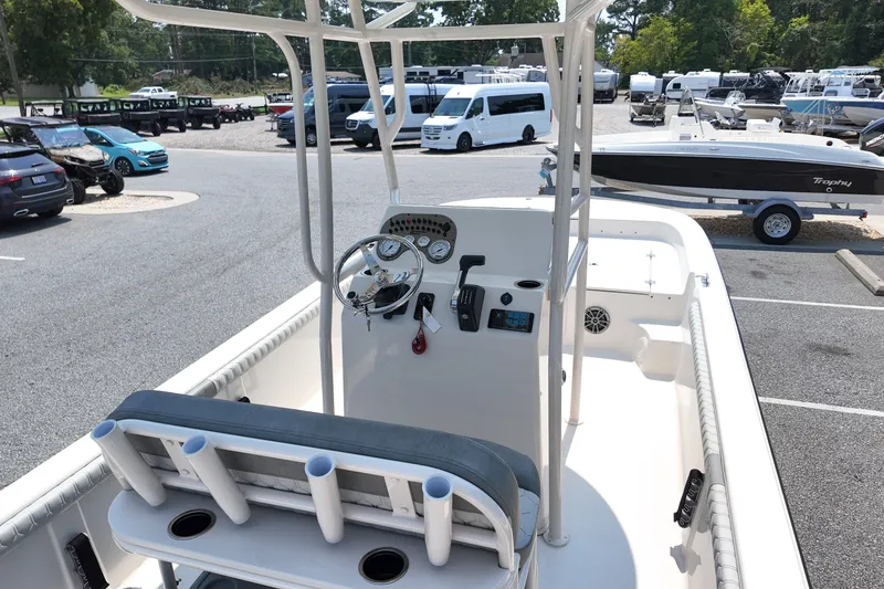 Slide: The Image of 2027 Carolina Skiff 21LS boat interior with steering console and rod holders. - 7