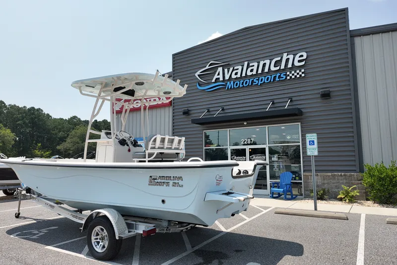 The Image of 2027 Carolina Skiff 21LS boat on trailer outside Avalanche Motorsports dealership. - 1