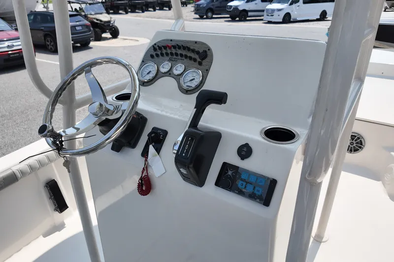 Slide: The Image of 2027 Carolina Skiff 21LS boat console with steering wheel and control panel. - 9
