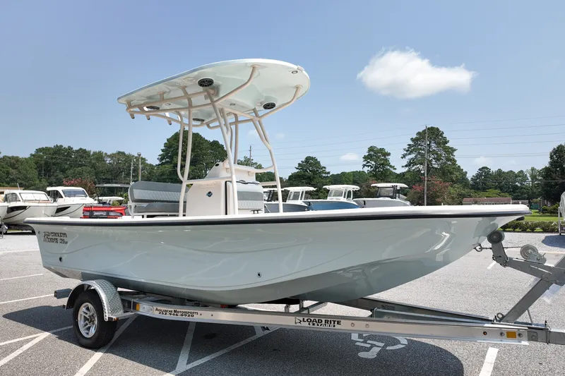Slide: The Image of 2027 Carolina Skiff 21LS boat on trailer in parking lot, clear sky background. - 3