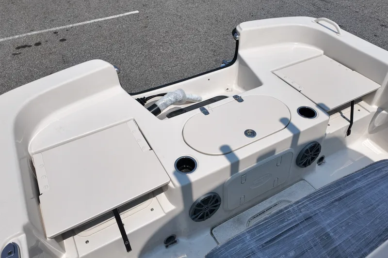 Slide: The Image of 2027 Carolina Skiff 21LS boat interior with storage compartments and cup holders. - 6