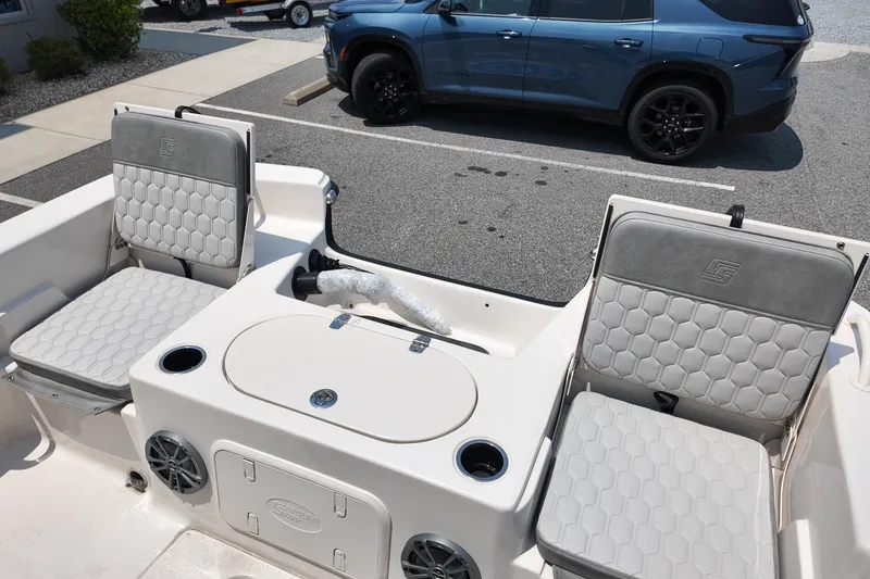 Slide: The Image of Interior of a 2027 Carolina Skiff 21LS boat with cushioned seating and storage compartments. - 21