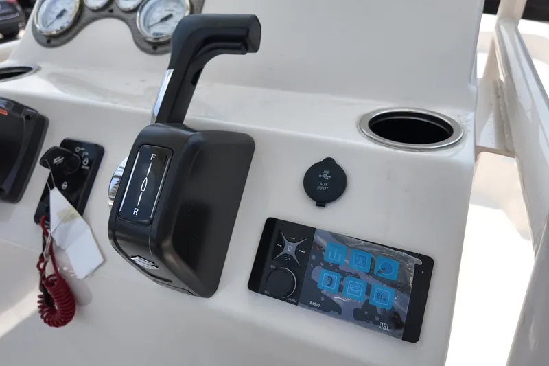 Slide: The Image of Control panel of a 2027 Carolina Skiff 21LS boat with throttle and display. - 19