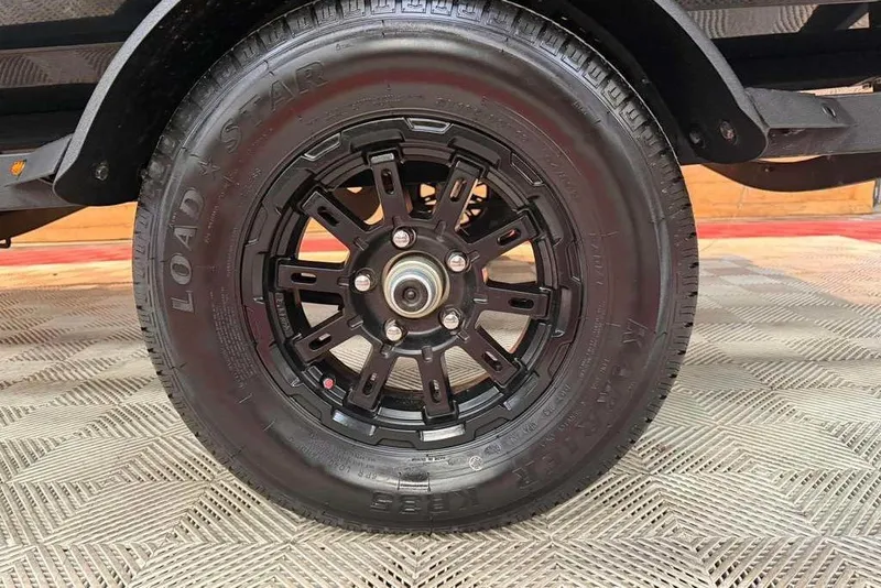 Slide: The Image of 2027 Tracker Pro Team 175 trailer wheel with black alloy rim and Load Star tire. - 10