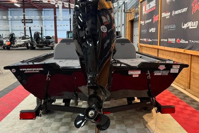 Slide: The Image of 2027 Tracker Pro Team 175 boat in showroom, rear view with motor. - 3