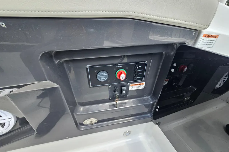 Slide: The Image of Control panel of 2022 Monterey 255SS Super Sport boat with switches and warning labels. - 23