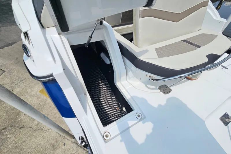 Slide: The Image of 2022 Monterey 255SS Super Sport boat with open storage compartment and cushioned seating. - 30