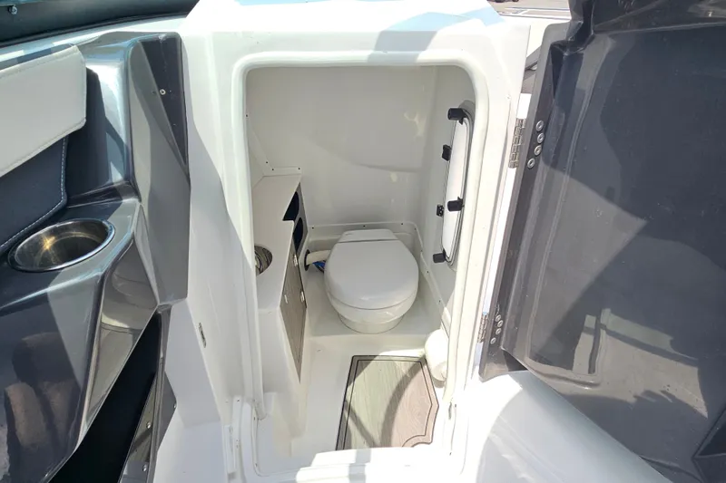 Slide: The Image of 2022 Monterey 255SS Super Sport boat interior with compact marine toilet. - 18