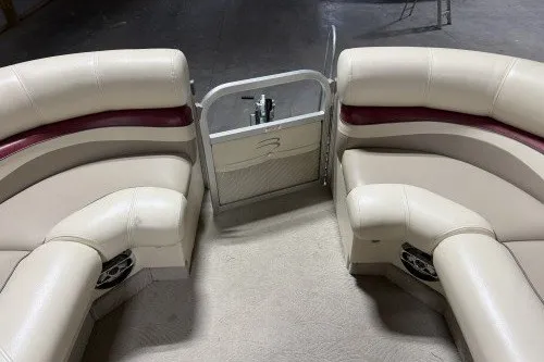 Slide: The Image of 2004 Bennington 2575 boat interior with beige seating and maroon accents. - 9
