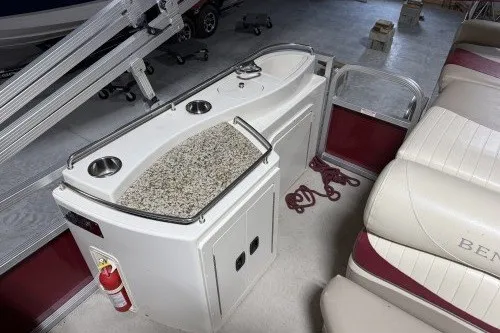 Slide: The Image of 2004 Bennington 2575 boat interior with kitchenette and seating area. - 4