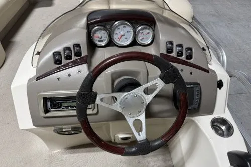 Slide: The Image of 2004 Bennington 2575 boat dashboard with gauges and steering wheel. - 6