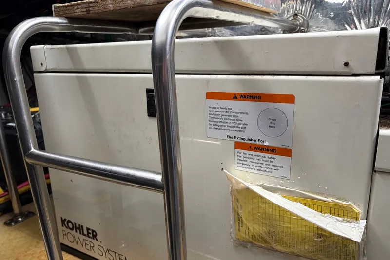 Slide: The Image of Kohler power system with warning labels on a Larson Cabrio 330, 2001 model. - 21