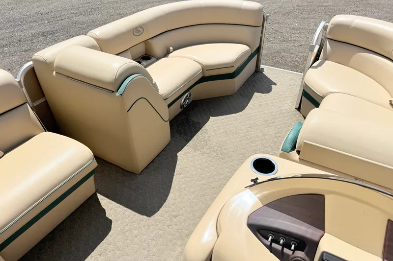 Slide: The Image of Luxurious seating on a 2015 South Bay 520CR pontoon boat, featuring beige upholstery. - 11