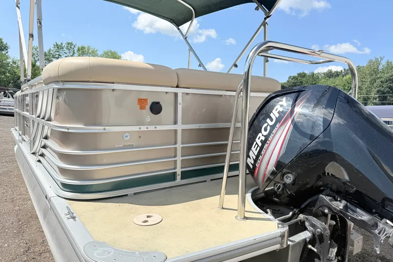 Slide: The Image of 2015 South Bay 520CR pontoon boat with Mercury outboard motor, docked outdoors. - 1
