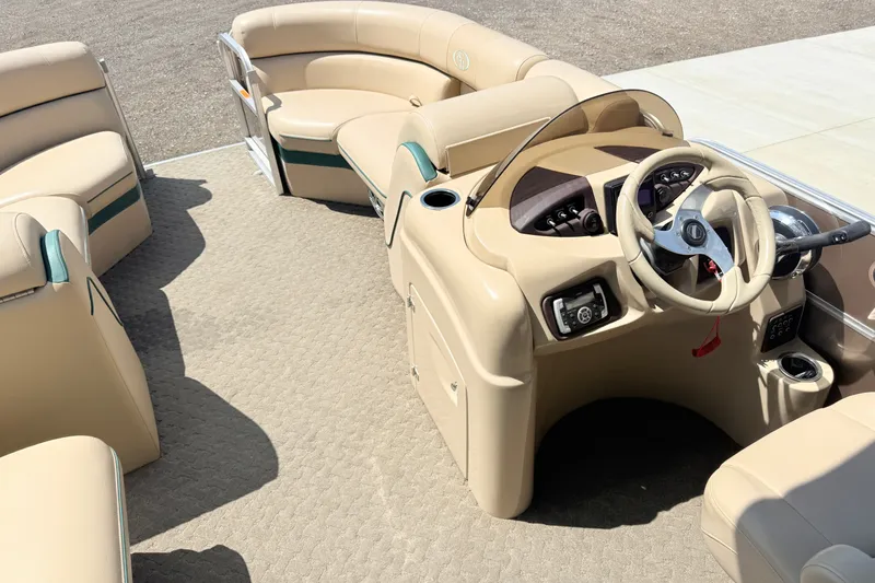 Slide: The Image of 2015 South Bay 520CR pontoon boat interior with beige seating and steering console. - 6