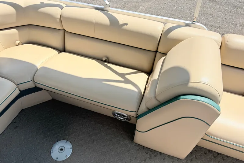 Slide: The Image of 2015 South Bay 520CR boat interior with beige seating and green accents. - 14