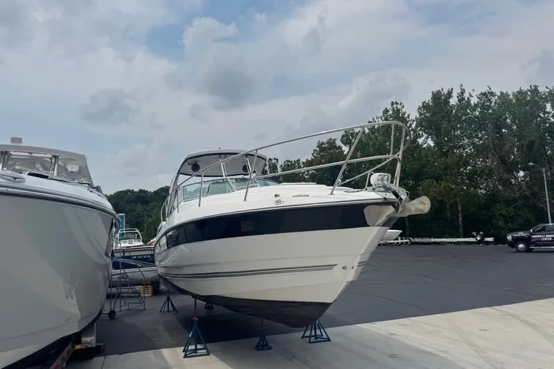 Slide: The Image of 2018 Monterey 355 Sport Yacht on stands, surrounded by trees and cloudy sky. - 3