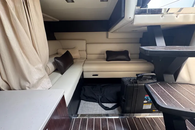 Slide: The Image of Interior of 2018 Monterey 355 Sport Yacht with beige seating and wooden accents. - 15