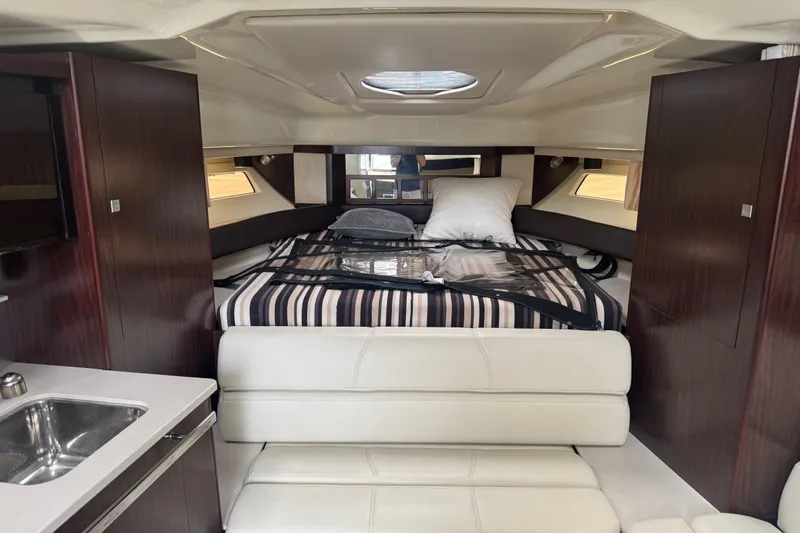 Slide: The Image of Interior of 2018 Monterey 355 Sport Yacht with bed, seating, and kitchenette. - 13