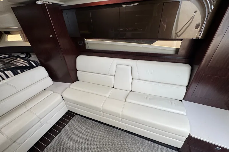 Slide: The Image of Luxurious interior of 2018 Monterey 355 Sport Yacht with white leather seating and dark wood accents. - 16