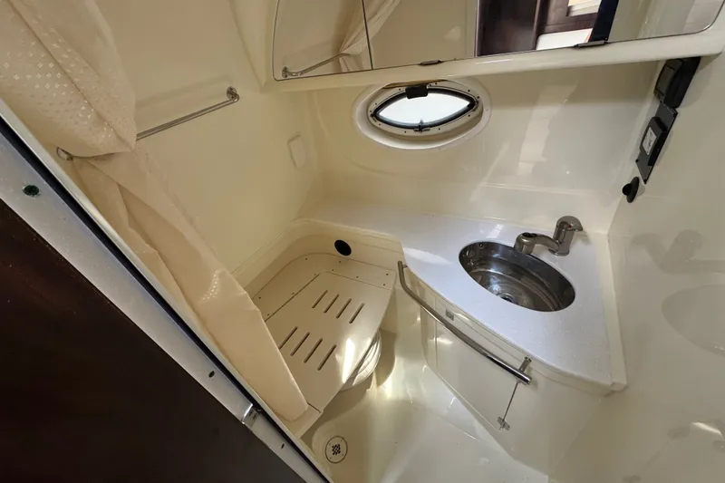Slide: The Image of Compact bathroom in 2018 Monterey 355 Sport Yacht with sink, shower, and porthole window. - 17