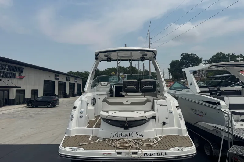 Slide: The Image of 2018 Monterey 355 Sport Yacht docked at a marina, showcasing sleek design and spacious deck. - 4