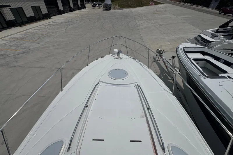 Slide: The Image of 2018 Monterey 355 Sport Yacht on display at a marina, viewed from the bow. - 5