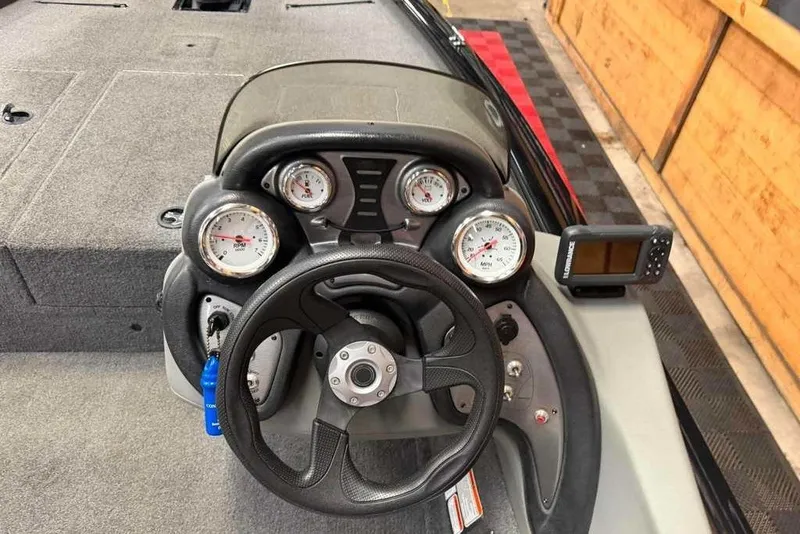 Slide: The Image of 2016 Tracker Pro Team 175 TXW boat dashboard with gauges and steering wheel. - 2
