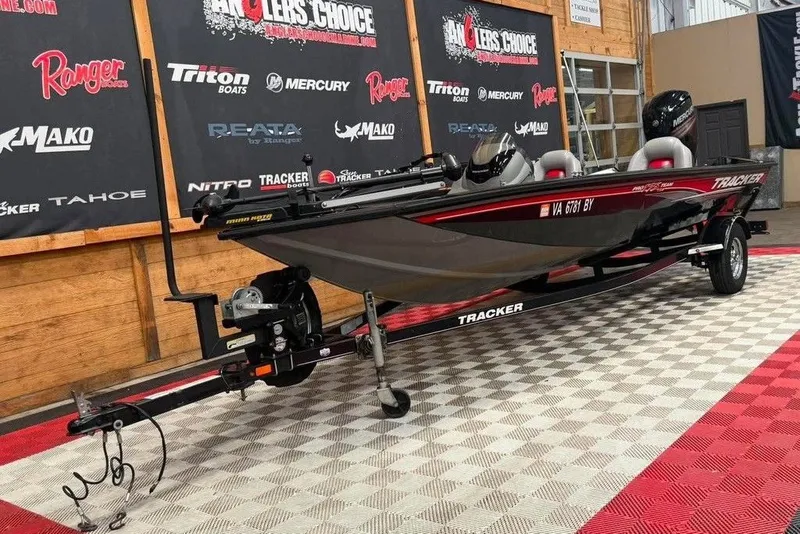 Slide: The Image of 2016 Tracker Pro Team 175 TXW boat on display in showroom with branded backdrop. - 5