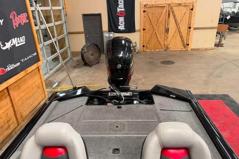 Slide: The Image of 2016 Tracker Pro Team 175 TXW boat in a showroom with motor and seating. - 6