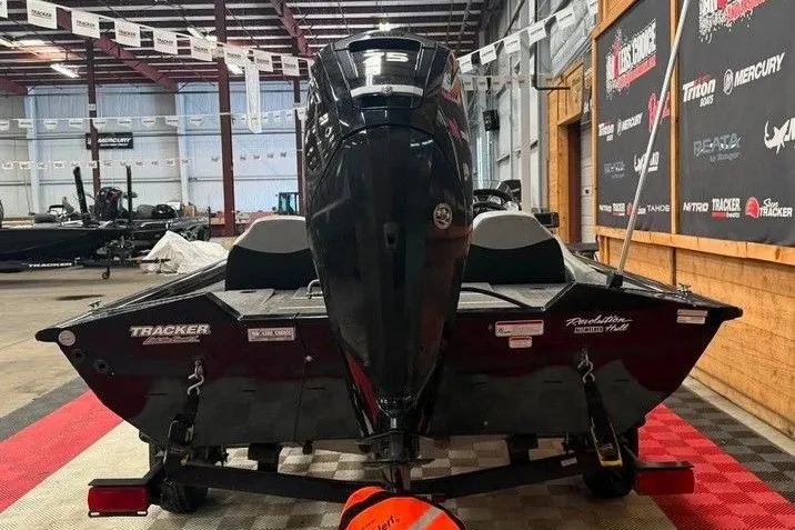 Slide: The Image of 2016 Tracker Pro Team 175 TXW boat displayed indoors, rear view with motor. - 3