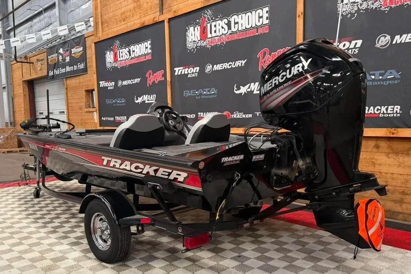 Slide: The Image of 2016 Tracker Pro Team 175 TXW boat with Mercury engine on display indoors. - 4