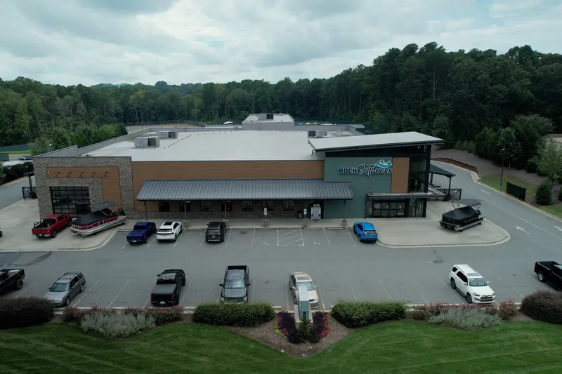 Slide: The Image of A modern building with several cars in the parking lot, surrounded by trees. - 4