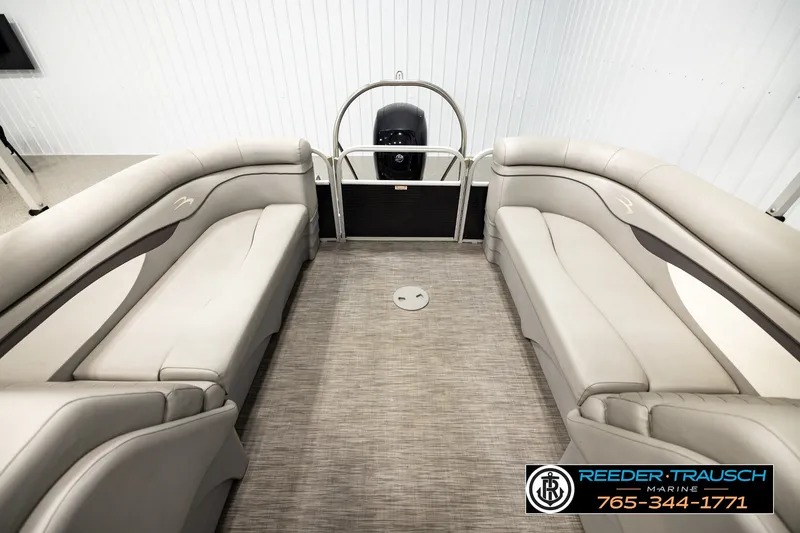 Slide: The Image of 2021 Bennington SVSR pontoon boat interior with beige seating and carpeted floor. - 15