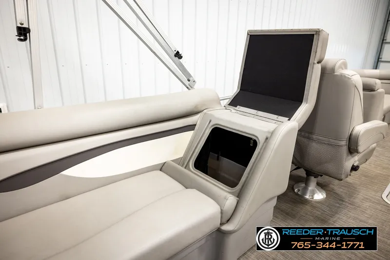 Slide: The Image of 2021 Bennington SVSR boat interior with open storage compartment and comfortable seating. - 29
