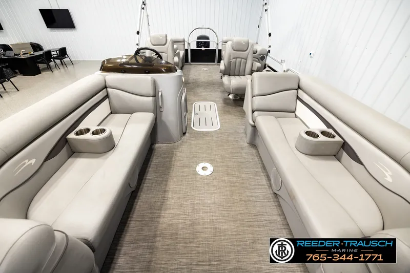 Slide: The Image of 2021 Bennington SVSR pontoon boat interior with plush seating and cup holders. - 13