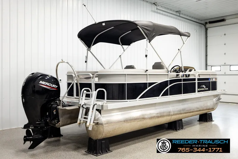 Slide: The Image of 2021 Bennington SVSR pontoon boat with Mercury engine in indoor showroom. - 6