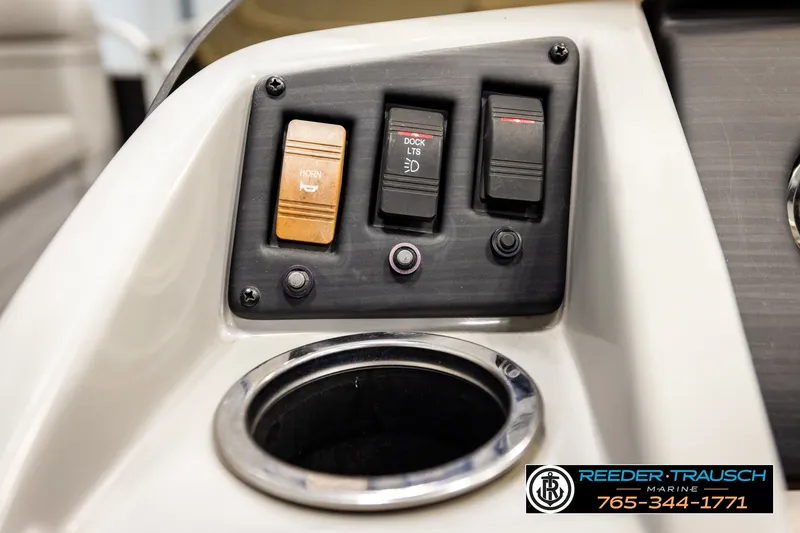Slide: The Image of Control panel of a 2021 Bennington SVSR boat with switches and cup holder. - 35